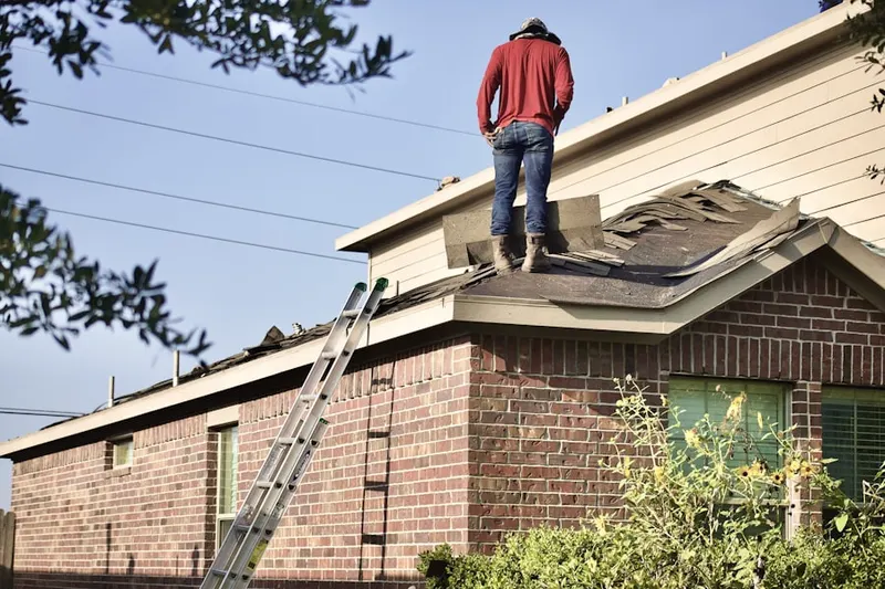Professional roofer working on a residential roof in Offutt Village